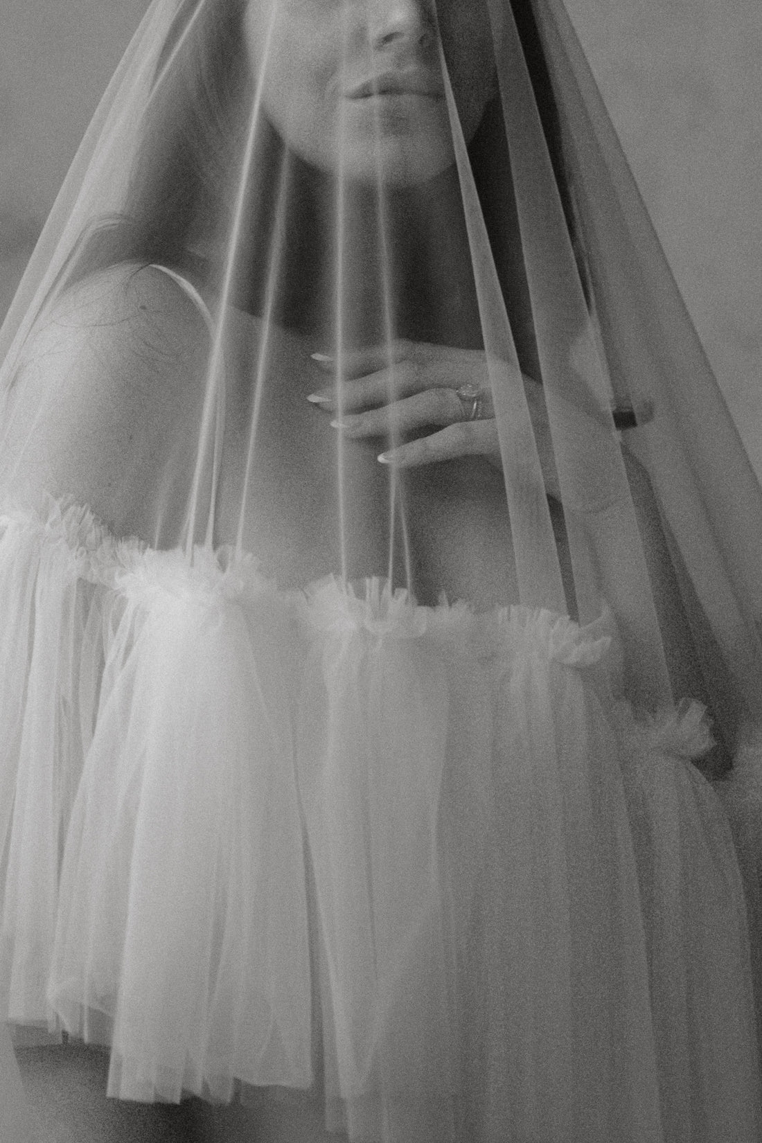Bride wearing a cathedral-length wedding veil during a luxury wedding ceremony.